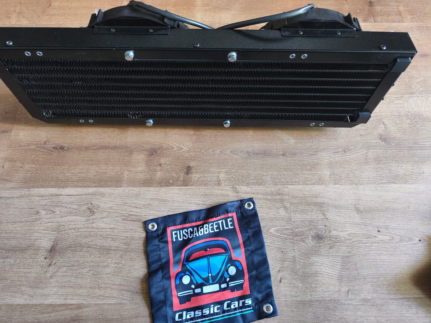 Electric air conditioning condenser for a VW Beetle, mounts behind the spare tire with no modifications required.